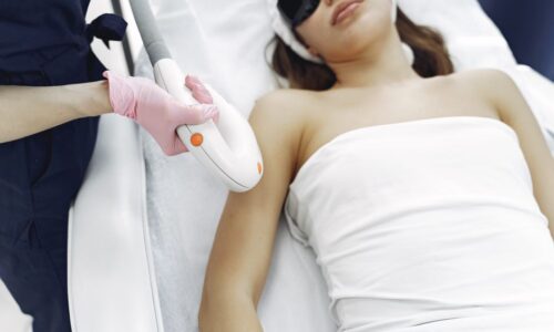 From above of unrecognizable cosmetologist in uniform and latex gloves using modern equipment for cosmetic services in contemporary salon - Photo by Gustavo Fring on Pexels